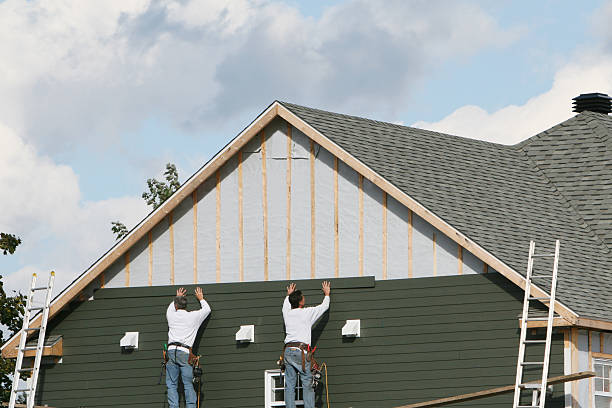 Professional Siding technician working in Springs, NY
